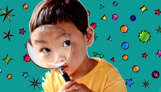 To spark curiosity, don’t tell preschoolers too much or too little child looking through a magnifying glass