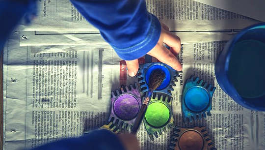 Can Parents Make The World A Better Place By Teaching Creativity? child's hand reaching for colors