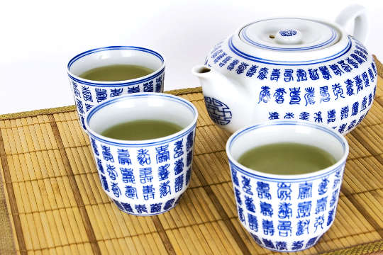 Can Green Tea Be Harmful to Your Health? tea swerved in traditional cups and teapot